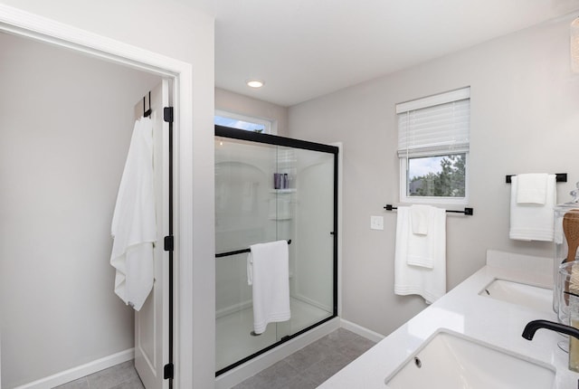 4892 Avery Ct, Eagan, MN 55123 - bathroom featuring baseboards, a shower stall, double vanity, tile patterned flooring, and recessed lighting