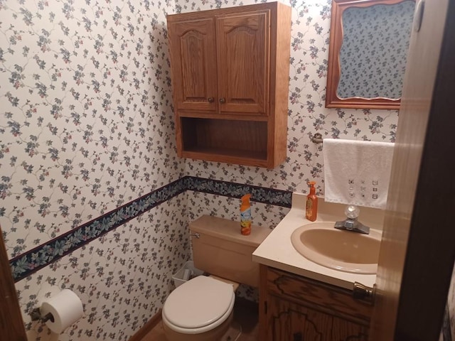 149 Riverview Dr Unit 5, Monticello, MN 55362 - bathroom featuring wallpapered walls, toilet, and vanity