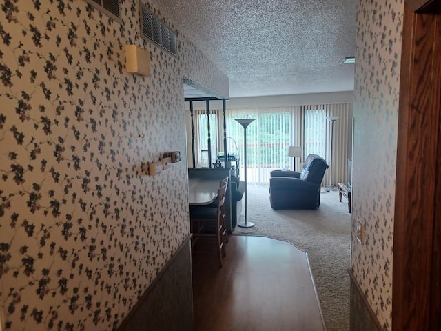 149 Riverview Dr Unit 5, Monticello, MN 55362 - hall with carpet floors, a textured ceiling, and wallpapered walls