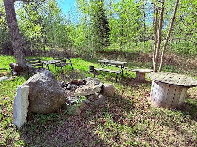 view of home's community with an outdoor fire pit