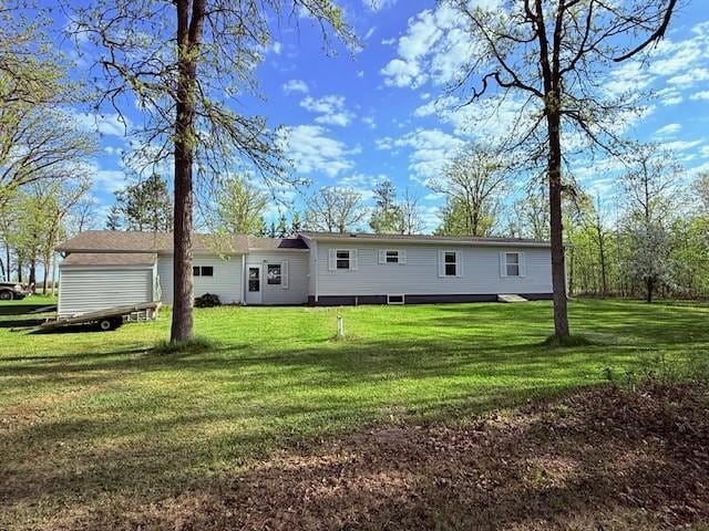 back of property with a lawn