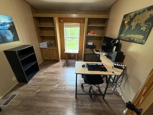 office space with wood finished floors and baseboards