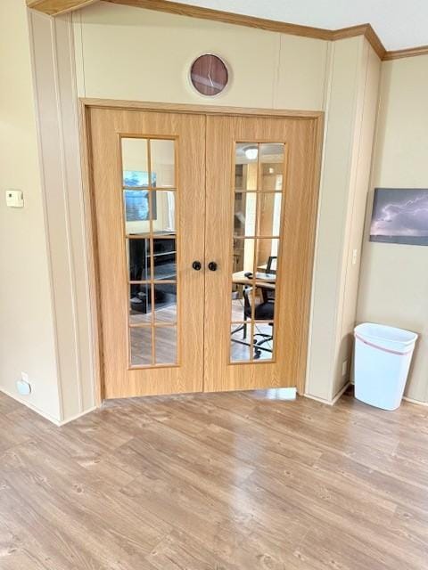 empty room with french doors and wood finished floors