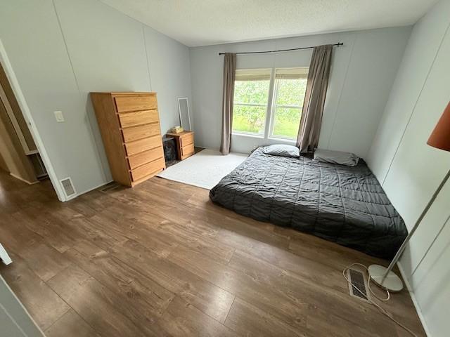 bedroom featuring wood finished floors