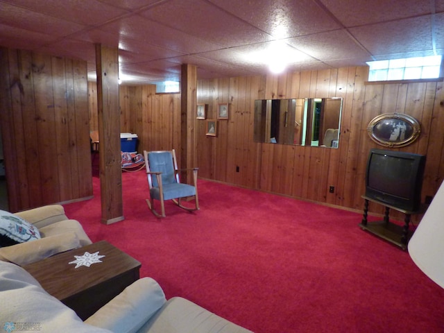 423 9th St N, Wahpeton, ND 58075 - carpeted living room with wood walls and a paneled ceiling