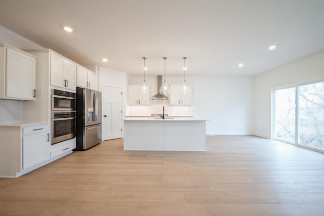 11405 Fieldstone Dr, Rogers, MN 55311 - kitchen with stainless steel appliances, wall chimney range hood, recessed lighting, light wood-type flooring, and white cabinets
