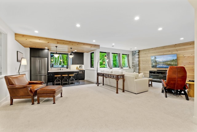 6407 Archer Ln N, Maple Grove, MN 55311 - living area with light carpet, wood walls, recessed lighting, baseboards, and an accent wall