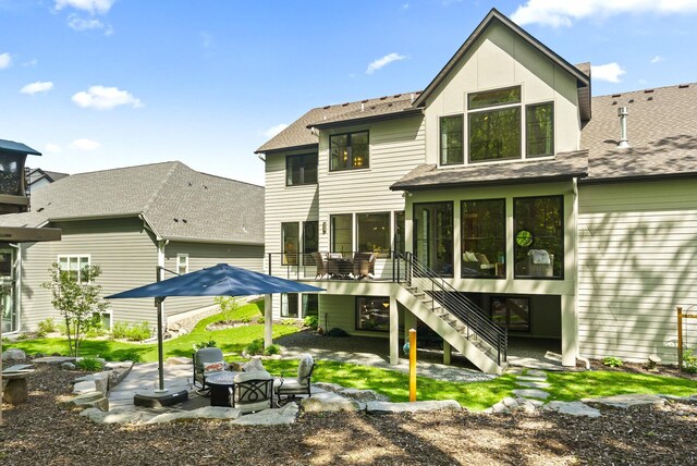 6407 Archer Ln N, Maple Grove, MN 55311 - back of house with stairs, a patio, a sunroom, and roof with shingles