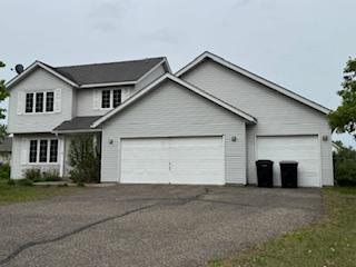 14720 Erkium St NW, Ramsey, MN 55303 - traditional-style house featuring asphalt driveway and an attached garage