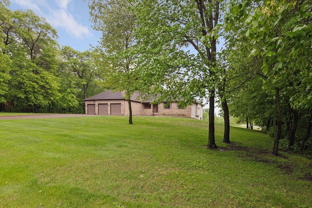 124 166th Ave NE, Andover, MN 55304 - view of grassy yard with driveway and a garage