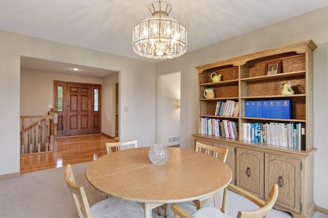 124 166th Ave NE, Andover, MN 55304 - dining space with a chandelier, light carpet, and baseboards