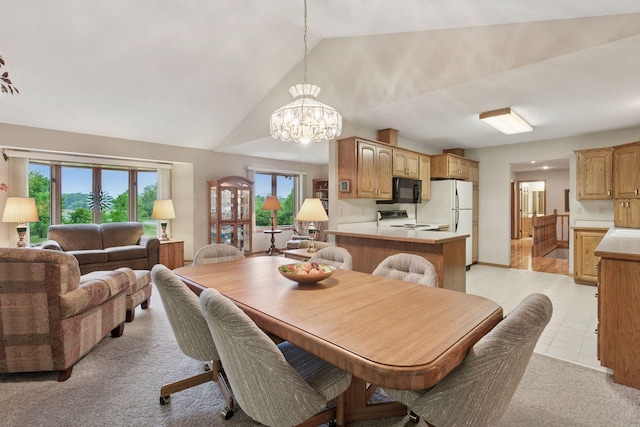 124 166th Ave NE, Andover, MN 55304 - dining room featuring lofted ceiling, a chandelier, light tile patterned floors, and light colored carpet