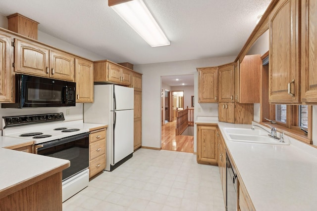 124 166th Ave NE, Andover, MN 55304 - kitchen featuring black microwave, range with electric cooktop, light countertops, a sink, and freestanding refrigerator