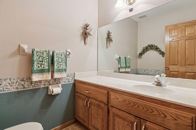 124 166th Ave NE, Andover, MN 55304 - half bath featuring vanity, wallpapered walls, and toilet
