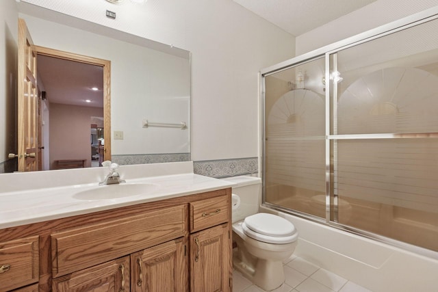 124 166th Ave NE, Andover, MN 55304 - bathroom with vanity, toilet, tile patterned flooring, and enclosed tub / shower combo