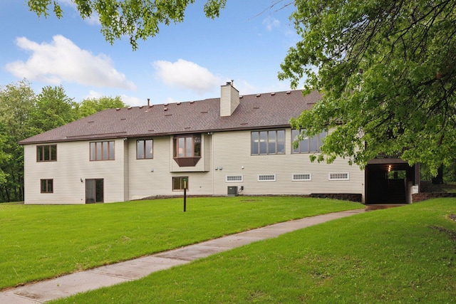 124 166th Ave NE, Andover, MN 55304 - back of house featuring a yard, a chimney, a shingled roof, and central AC unit