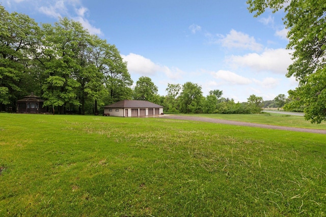 124 166th Ave NE, Andover, MN 55304 - view of grassy yard featuring a garage