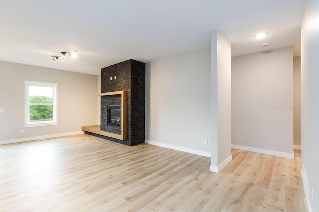 415 Moelter Ln, Troy Twp, WI 54016 - unfurnished living room with wood finished floors, a fireplace, and baseboards
