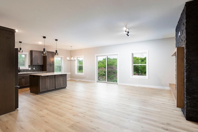 415 Moelter Ln, Troy Twp, WI 54016 - kitchen with open floor plan, light countertops, baseboards, and light wood-style floors