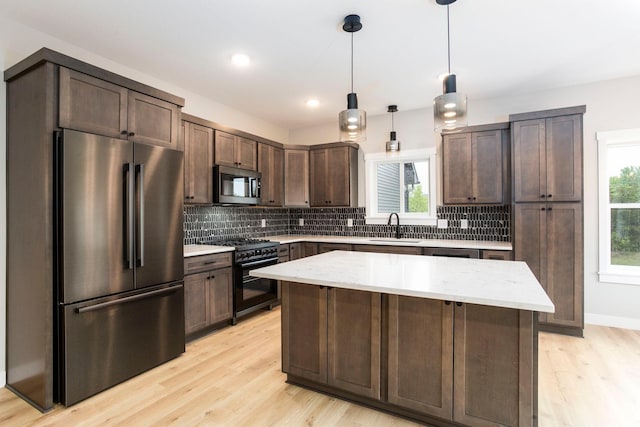 415 Moelter Ln, Troy Twp, WI 54016 - kitchen featuring stainless steel appliances, a sink, backsplash, light wood-style flooring, and recessed lighting