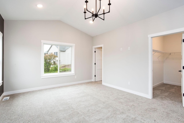 415 Moelter Ln, Troy Twp, WI 54016 - unfurnished bedroom featuring a chandelier, carpet floors, a spacious closet, vaulted ceiling, and baseboards
