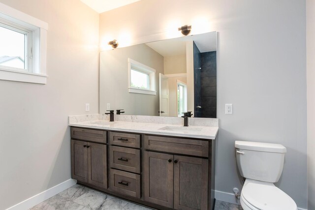 415 Moelter Ln, Troy Twp, WI 54016 - full bath with baseboards, double vanity, toilet, and marble look tiles