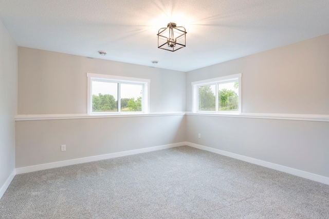 415 Moelter Ln, Troy Twp, WI 54016 - carpeted empty room featuring a chandelier, baseboards, and a smoke detector