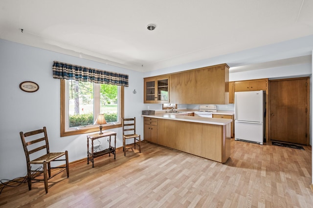1213 Highview Dr, New Brighton, MN 55112 - kitchen with white appliances, a peninsula, a sink, light countertops, and light wood finished floors