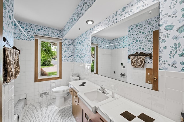 1213 Highview Dr, New Brighton, MN 55112 - full bathroom featuring wallpapered walls, tile walls, tiled shower, tile patterned floors, and wainscoting