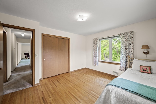 1213 Highview Dr, New Brighton, MN 55112 - bedroom featuring light wood-style floors, baseboards, and a closet