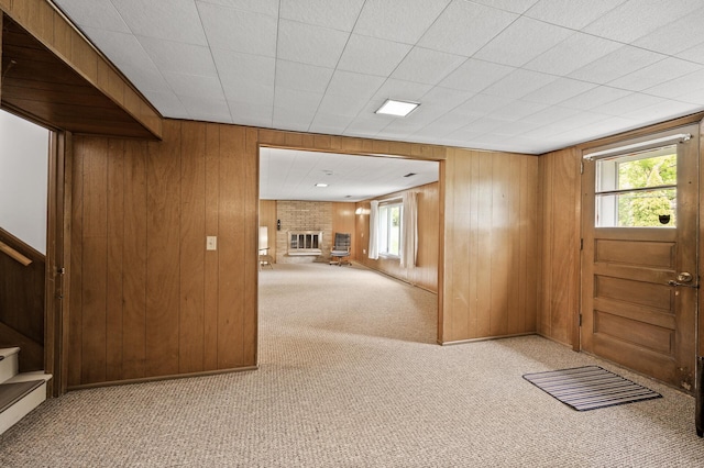 1213 Highview Dr, New Brighton, MN 55112 - entrance foyer featuring carpet floors, wood walls, stairs, healthy amount of natural light, and a fireplace