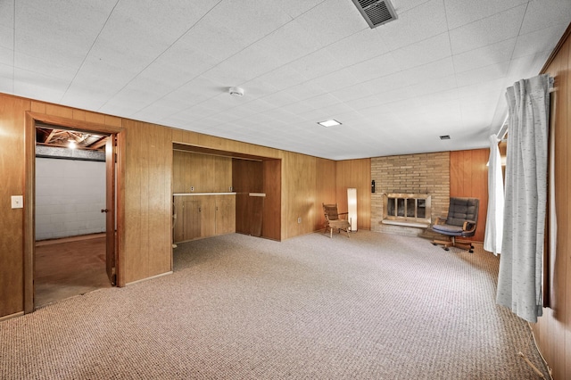 1213 Highview Dr, New Brighton, MN 55112 - unfurnished living room featuring wooden walls, carpet floors, and a brick fireplace