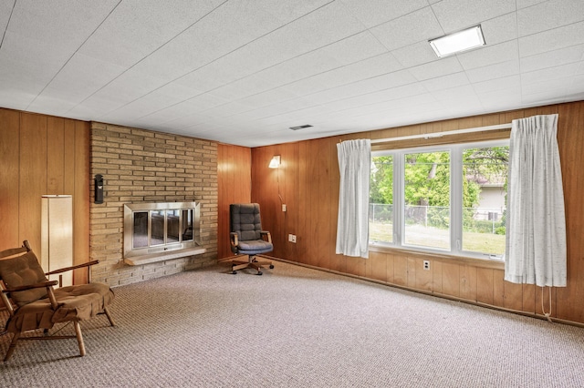 1213 Highview Dr, New Brighton, MN 55112 - living area featuring carpet, wood walls, and a brick fireplace