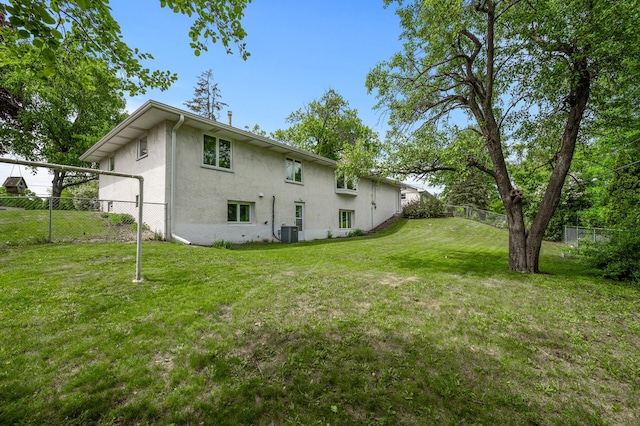 1213 Highview Dr, New Brighton, MN 55112 - rear view of house with stucco siding and central AC unit