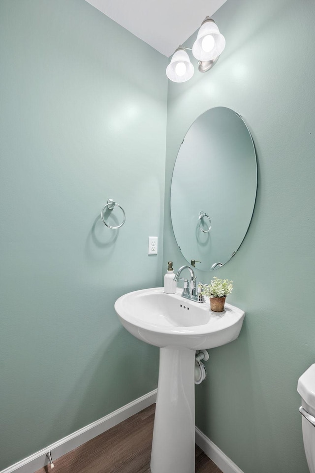 8857 152nd Ln NW, Ramsey, MN 55303 - half bathroom featuring wood finished floors and baseboards