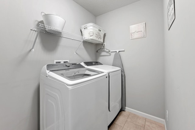 8857 152nd Ln NW, Ramsey, MN 55303 - washroom with washer and clothes dryer and light tile patterned floors
