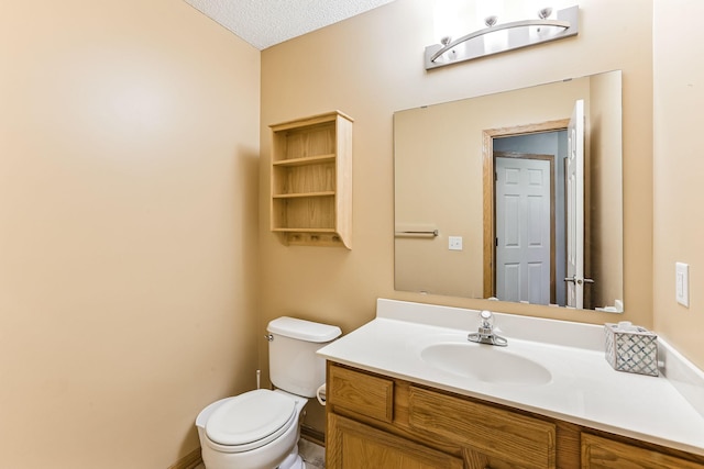 10938 181st Ln NW, Elk River, MN 55330 - bathroom featuring toilet, vanity, and a textured ceiling
