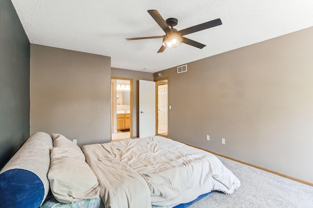 10938 181st Ln NW, Elk River, MN 55330 - bedroom featuring carpet, baseboards, a ceiling fan, a textured ceiling, and ensuite bathroom