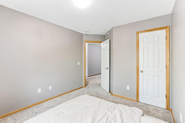 10938 181st Ln NW, Elk River, MN 55330 - bedroom with light carpet, baseboards, and a textured ceiling