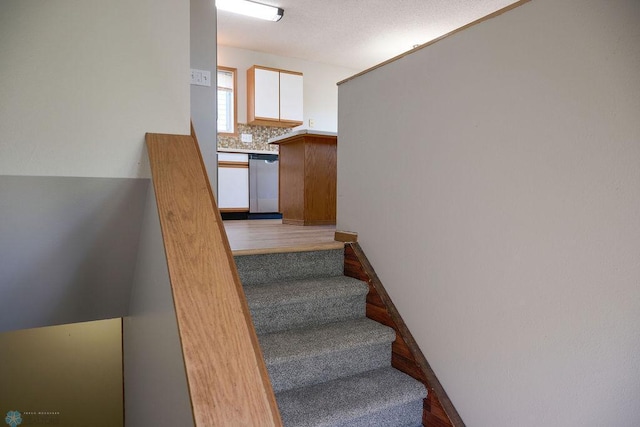 stairway with wood finished floors
