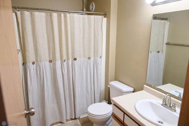 full bathroom with toilet, vanity, and a shower with shower curtain