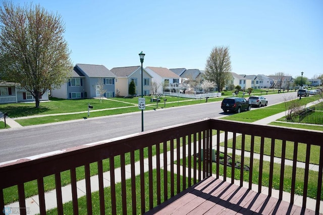 deck with a residential view, cooling unit, and a yard