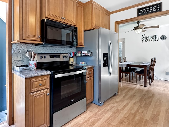 550 Center St, Tracy, MN 56175 - kitchen with appliances with stainless steel finishes, light wood-style flooring, decorative backsplash, ceiling fan, and brown cabinetry