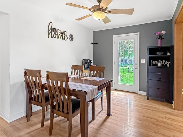 550 Center St, Tracy, MN 56175 - dining room featuring light wood-style floors, a ceiling fan, crown molding, and baseboards