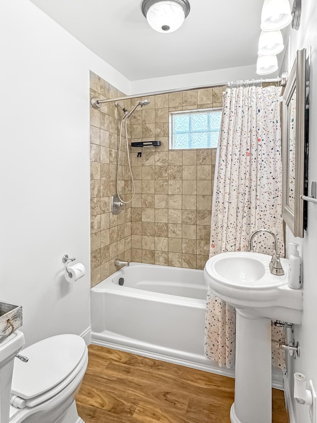 550 Center St, Tracy, MN 56175 - bathroom featuring wood finished floors, shower / bath combination with curtain, and toilet