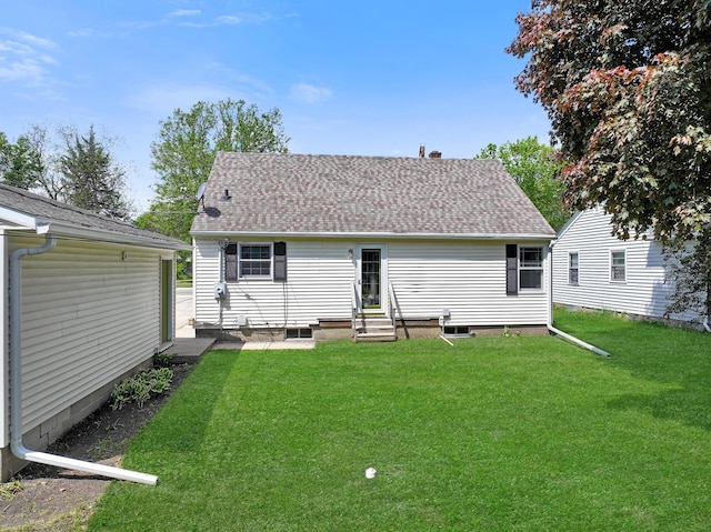 550 Center St, Tracy, MN 56175 - back of property with entry steps, a yard, and roof with shingles