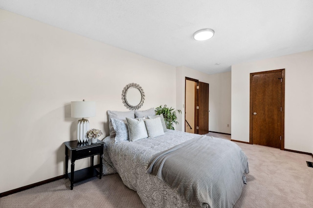 bedroom with light carpet and baseboards