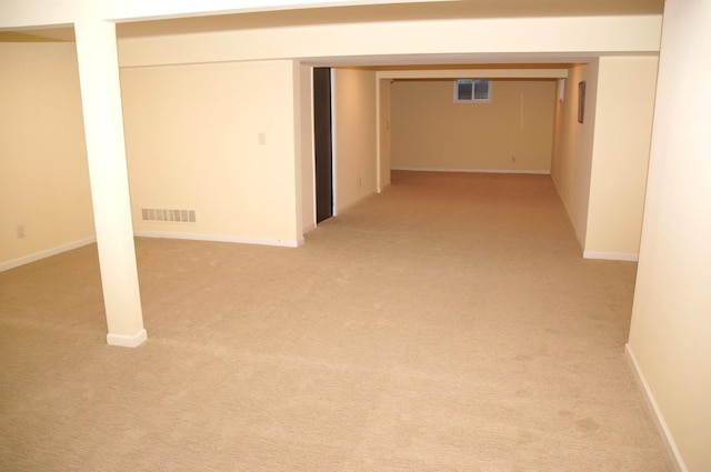 finished basement with light carpet and baseboards