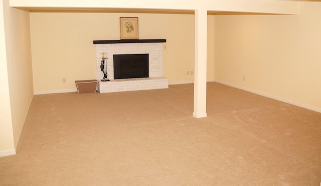 basement with carpet flooring, a fireplace, and baseboards