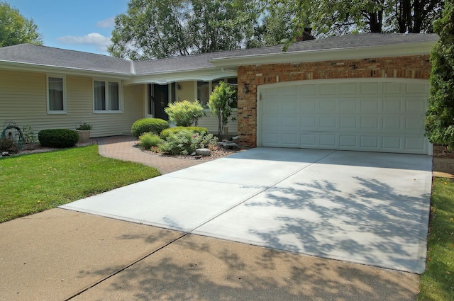 ranch-style home with driveway, a garage, a front lawn, roof with shingles, and brick siding